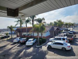 a group of cars parked in a parking lot at Budget Inn in Corcoran