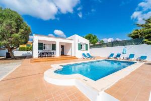 a villa with a swimming pool and a house at Villa Patri in Cala'n Porter