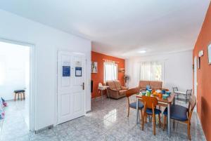 a dining room and living room with a table and chairs at Villa Patri in Cala'n Porter
