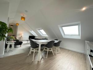 a living room and dining room with a table and chairs at Stunning Penthouse in Penzance "Amazing Sea Views" in Penzance +23 photos