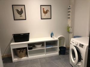 a white shelf in a laundry room with a washing machine at Le Clos des Marronniers n°1050 in Ecques