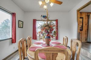 a dining room table with a vase of flowers on it at Hummingbird Haven - Charming Ruidoso Retreat home in Ruidoso +22 photos