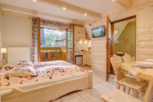 1 dormitorio y comedor con 1 cama y 1 mesa en Willa Vera Zakopane, en Zakopane