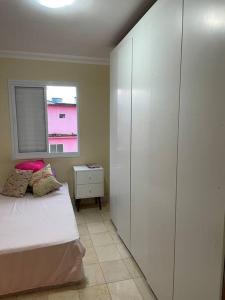 a bedroom with a bed and a window at Apto mobiliado, 50 metros da praia. in Angra dos Reis
