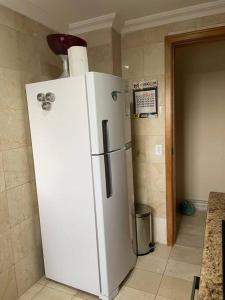 a white refrigerator in a kitchen with a counter at Apto mobiliado, 50 metros da praia. in Angra dos Reis