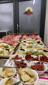 una línea de buffet con muchos tipos diferentes de comida en Agriturismo Casale Lisalola, en Sutri