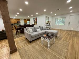 a living room with a couch and a table at Lake Pearl House in Lake Placid