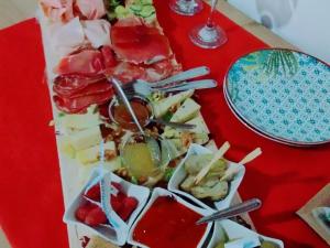 a tray of food on a red table at Agriturismo Casale Lisalola in Sutri
