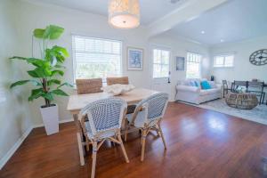 a dining table and chairs in a living room at Sea View, Flower Garden, A/c, W/d, Renovated in Hermosa Beach