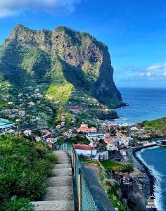 a view of a mountain next to the ocean at Casa Jardim in Ponta do Pargo +25 photos