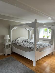 a bedroom with a white bed with a canopy at 300m2 entire house with 3 bedrooms in Tistrup