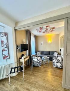 a living room with a couch and chairs in it at Best Western Hôtel De La Bourse in Mulhouse