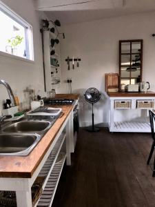 a kitchen with a sink and a stove at Urban Plett in Plettenberg Bay