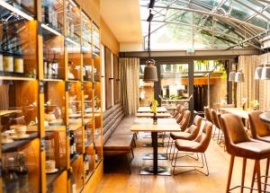 a restaurant with tables and chairs and windows at Der Thaller - Wirtshaus - Restaurant - Hotel in Anger