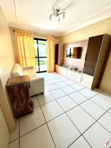 a living room with a couch and a tv at Aquaville Resort in Aquiraz +19 photos