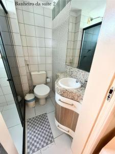 a bathroom with a toilet and a sink at Aquaville Resort in Aquiraz