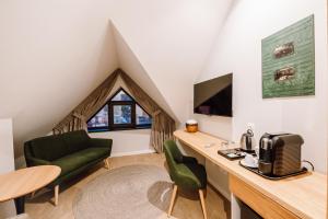 a small living room with a green couch and a table at Pensiunea Sylvania in Sovata