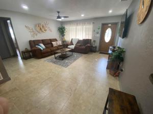 a living room with a couch and a table at Close to beaches Pet friendly heated pool hot tub in Largo