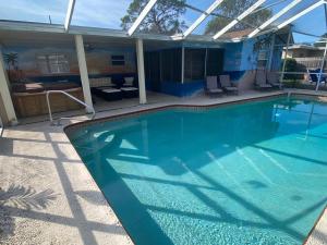 a large swimming pool with a pergola over it at Close to beaches Pet friendly heated pool hot tub in Largo