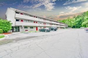 a large building with cars parked in front of it at Economy Hotel Atlanta in Atlanta