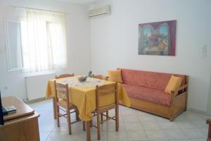 a living room with a table and a couch at Maria & Kyros House in Parga