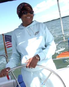 una mujer parada en el frente de un barco en Williamsburg Charter Sails / Let's Go Sail, 