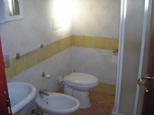 a bathroom with a white toilet and a sink at robbyone 2 in Olbia