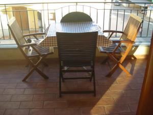 a table and chairs on top of a balcony at robbyone 2 in Olbia