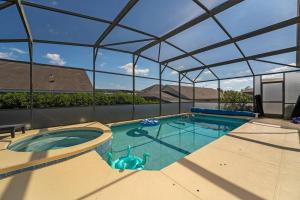 a large swimming pool with a canopy over it at Poolside Orlando Oasis in Orlando