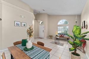 a dining room with a table and a room with plants at Poolside Orlando Oasis in Orlando