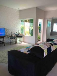 a bedroom with a bed and a tv in it at Casa de Praia in Cananéia
