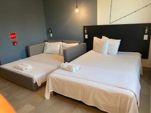 מיטה או מיטות בחדר ב-Front Comfort Teófilo Otoni