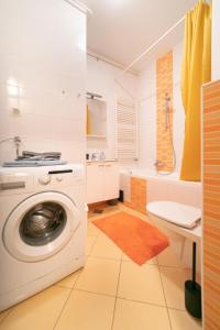 a bathroom with a washing machine and a sink at Trendy apartment 5 min to city centre!` in Zagreb