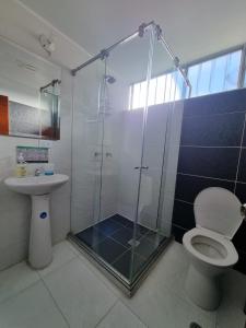 a bathroom with a shower and a toilet and a sink at Florentina in Tunja