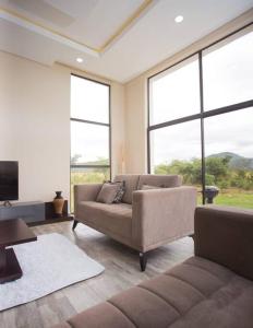 a living room with a couch and large windows at Mountain View Villa 