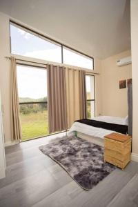a bedroom with a bed and a large window at Mountain View Villa 