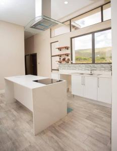 a large kitchen with white cabinets and a sink at Mountain View Villa 