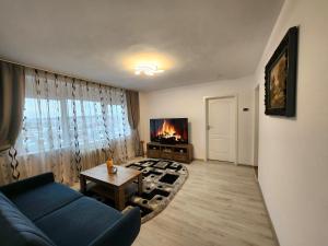 a living room with a blue couch and a fireplace at Apartament 3 camere Palas in Iaşi