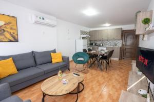 a living room with a couch and a table at Napa Centrale Suites in Ayia Napa