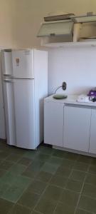 a kitchen with two white refrigerators in a room at Residencial Brilha Mar in Capão da Canoa