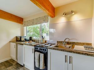 a kitchen with a stove and a sink at 1 Bed in Loweswater 89111 in Workington