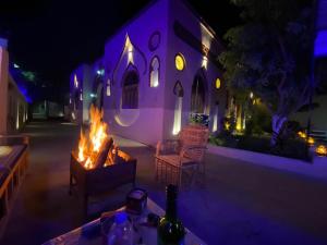 a house with a fire in a courtyard at night at Luxor Villa Hatshepsut in Luxor