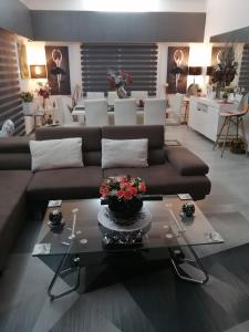 a living room with a brown couch and a table at Andros Residence in Limassol