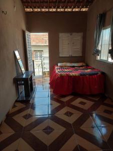 a bedroom with a bed and a table in a room at Casa do diego in Aracati