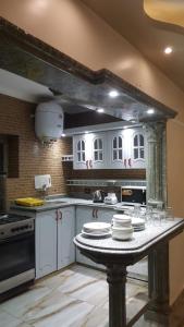 a kitchen with a table with plates on it at City Square شقق فندقية مكيفة باطلالة علي البحر in Alexandria