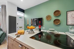 a kitchen with a counter top with a bottle of wine at 3 Bed Spacious Stylish House, Central Portsmouth Sleeps 6, Parking - By Blue Puffin Stays in Portsmouth