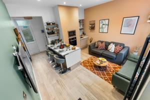 a kitchen and living room with a couch and a table at 3 Bed Spacious Stylish House, Central Portsmouth Sleeps 6, Parking - By Blue Puffin Stays in Portsmouth