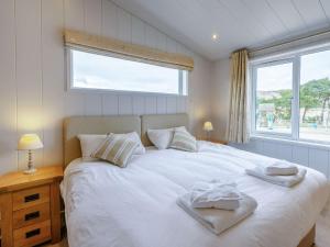 a bedroom with a large white bed with a window at 3 Bed in St Andrews 88545 in Balmullo