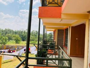 a balcony of a house with a view of a yard at Gem in Busia