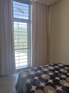 1 dormitorio con cama y ventana grande en Casa Serrana en Córdoba
